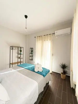 a bedroom with a large bed with towels on it at Athenian Petralona Suite near Athens City centre in Athens