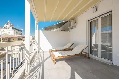 a balcony with a chair and a balcony at Spacious Athens Apt Large Balcony 200m to Metro in Athens