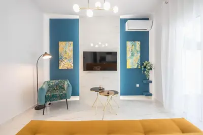 a living room with a couch and a chair at Spacious Athens Apt Large Balcony 200m to Metro in Athens