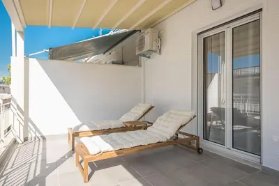 a porch with a bench on a balcony at Spacious Athens Apt Large Balcony 200m to Metro in Athens