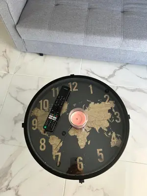 a black table with a clock and a remote control at Cozy apartment in lycabettus hills in Athens