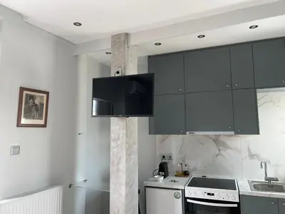 a kitchen with black cabinets and a sink at Cozy apartment in lycabettus hills in Athens