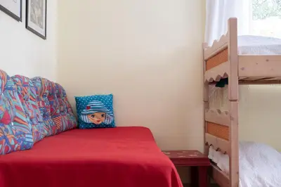 a bedroom with a bunk bed and a ladder at Family home in Lagonisi in Lagonissi
