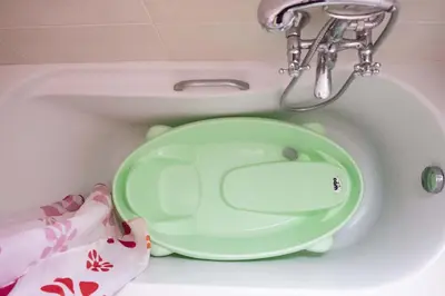 a green plate is sitting in a bath tub at Family home in Lagonisi in Lagonissi