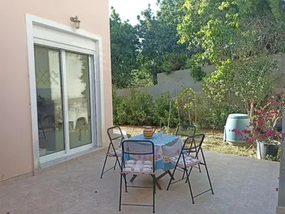 a table and chairs sitting on a patio at Family home in Lagonisi in Lagonissi