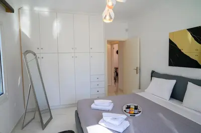 a bedroom with a bed with towels on it at Seclusion, Privacy and 2 bedroom Luxury in Glyfada in Athens