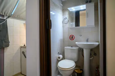 a small bathroom with a toilet and a sink at Premium Athenian District Urban Studio in Athens