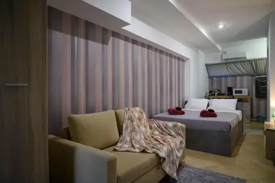a hotel room with a bed and a couch at Premium Athenian District Urban Studio in Athens
