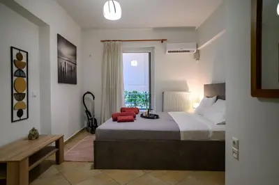 a bedroom with a large bed and a window at Premium Athenian District Urban 1 bedroom flat A in Athens