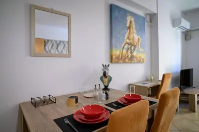 a dining room with a table with a horse painting on the wall at Premium Athenian District Urban 1 bedroom flat A in Athens