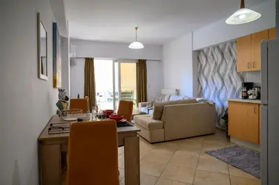 a kitchen and living room with a table and a couch at Premium Athenian District Urban 1 bedroom flat A in Athens
