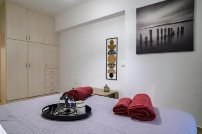 a bedroom with a bed with red towels on it at Premium Athenian District Urban 1 bedroom flat A in Athens