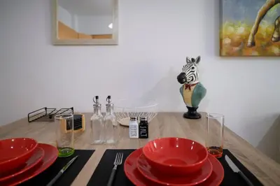 a wooden table with red plates and glasses on it at Premium Athenian District Urban 1 bedroom flat A in Athens