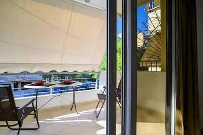 a room with a balcony with a table and a window at Premium Athenian District Urban 1 bedroom flat A in Athens