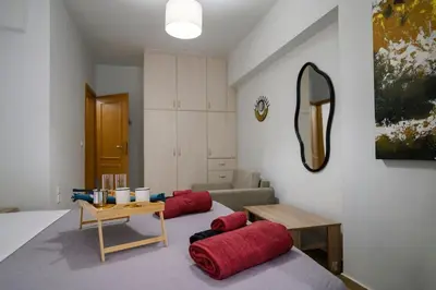 a bedroom with two red pillows on a bed at Premium Athenian District Urban 1 bedroom flat B in Athens