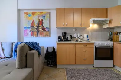 a living room with a couch and a kitchen at Premium Athenian District Urban 1 bedroom flat B in Athens