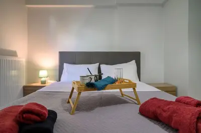 a bedroom with a bed with a table on it at Premium Athenian District Urban 1 bedroom flat B in Athens