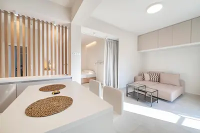 a living room with a white table and chairs at Oculus Kallithea Creators Hub&Suite by Live&Travel in Athens