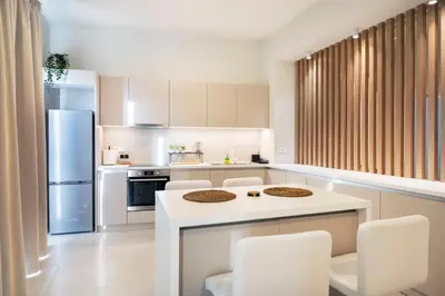 a kitchen with white cabinets and a white counter top at Oculus Kallithea Creators Hub&Suite by Live&Travel in Athens