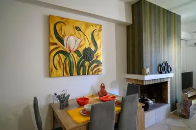 a dining room with a table and a painting on the wall at Premium Athenian District Urban 1 bedroom flat C in Athens