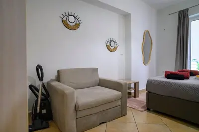 a living room with a chair and a bed at Premium Athenian District Urban 1 bedroom flat C in Athens