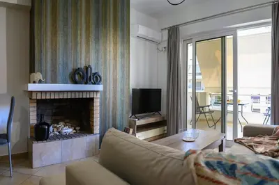 a living room with a couch and a fireplace at Premium Athenian District Urban 1 bedroom flat C in Athens