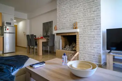 a living room with a table and a fireplace at Premium Athenian District Urban 1 bedroom Flat D in Athens