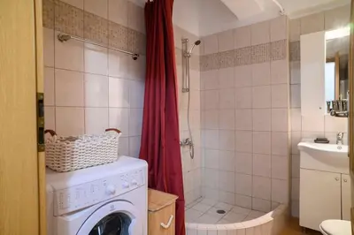 a bathroom with a washing machine and a shower at Premium Athenian District Urban 1 bedroom Flat D in Athens