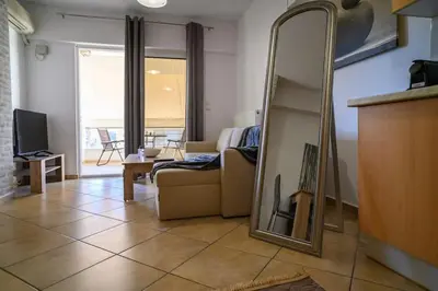 a living room with a mirror and a couch at Premium Athenian District Urban 1 bedroom Flat D in Athens