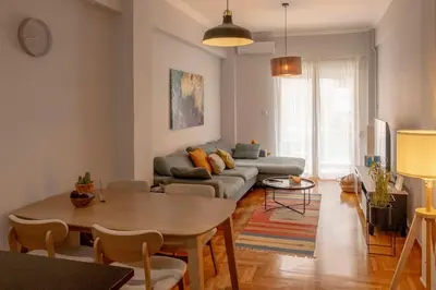 a living room with a couch and a table at Fresh&comfy4family & friends in Athens