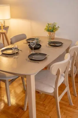 a white table with plates and wine glasses on it at Fresh&comfy4family & friends in Athens