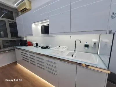 a white kitchen with a sink and a refrigerator at AS luxury apartment in Athens