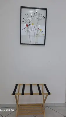 a bench in front of a picture on a wall at AS luxury apartment in Athens