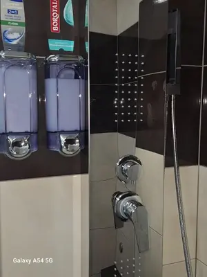 a shower in a bathroom with a shower head at AS luxury apartment in Athens