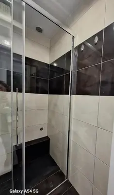 a walk in shower with glass doors in a bathroom at AS luxury apartment in Athens