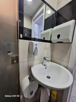 a bathroom with a white sink and a mirror at AS luxury apartment in Athens