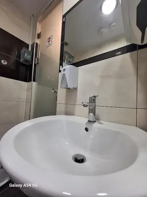 a bathroom with a white sink and a mirror at AS luxury apartment in Athens