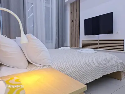 a bedroom with a bed with a flat screen tv at AS luxury apartment in Athens