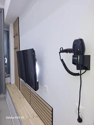 a television hanging on a wall in a room at AS luxury apartment in Athens