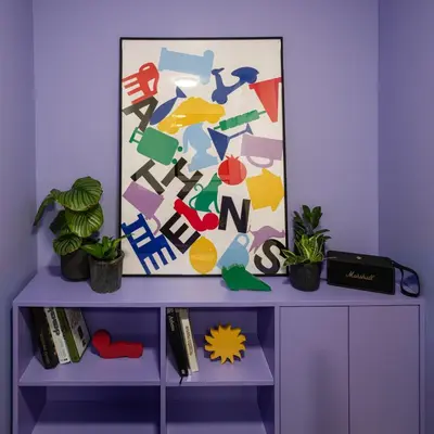 a purple shelf with a painting on it with plants at Fits Living in Athens