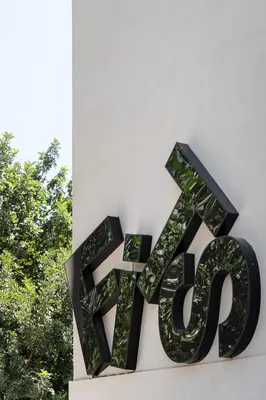 a large black sign on the side of a building at Fits Living in Athens