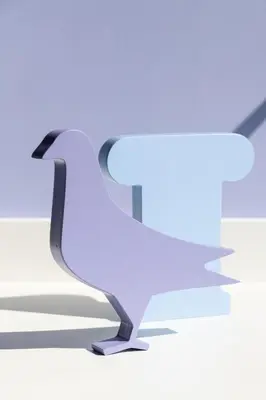 a white bird is sitting on the ground at Fits Living in Athens