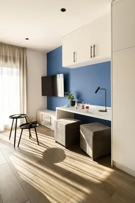 a kitchen with blue walls and a table and a chair at Fits Living in Athens
