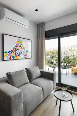 a living room with a couch and a large window at Fits Living in Athens