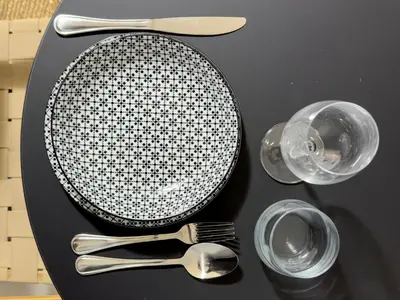 a plate and cutlery on a black table at Zen Athens City Center in Athens