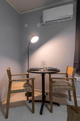 a table with two chairs and a lamp and a table with at Zen Athens City Center in Athens