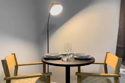 a small table with two chairs and a lamp at Zen Athens City Center in Athens