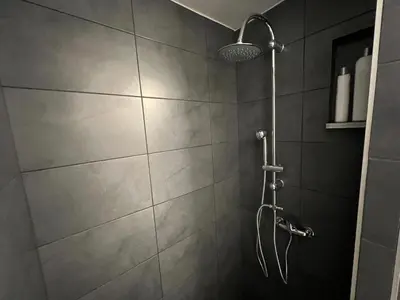 a shower with a shower head in a bathroom at Ground floor appartment Panormou Metro in Athens
