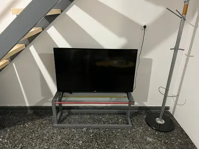 a television sitting on a glass table in a room at Ground floor appartment Panormou Metro in Athens
