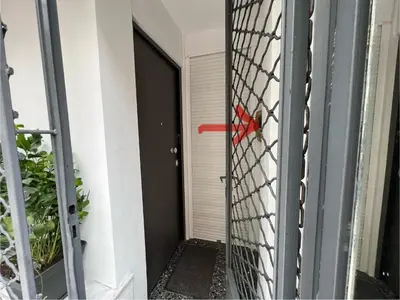 a gate with a red object in front of a door at Ground floor appartment Panormou Metro in Athens